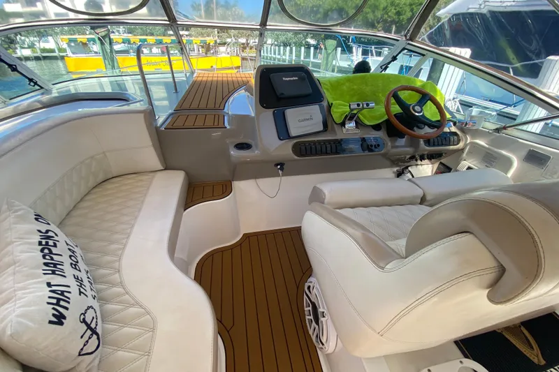 Slide: The Image of 2002 Cruisers Yachts 3572 Express cockpit with plush seating and modern navigation equipment. - 20