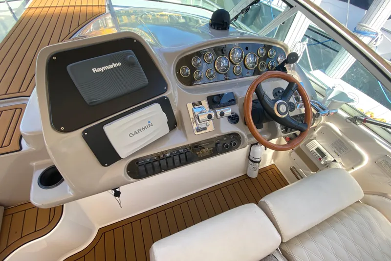 Slide: The Image of 2002 Cruisers Yachts 3572 Express helm with Raymarine and Garmin navigation systems. - 22