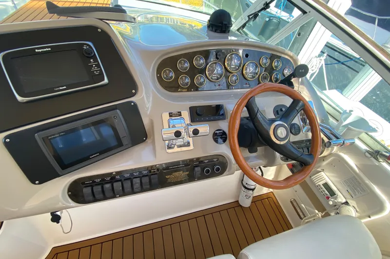 Slide: The Image of Cockpit of 2002 Cruisers Yachts 3572 Express with steering wheel and navigation instruments. - 24