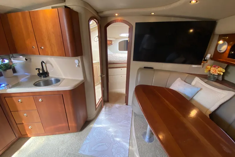 Slide: The Image of Luxurious interior of 2002 Cruisers Yachts 3572 Express with kitchenette and seating area. - 28