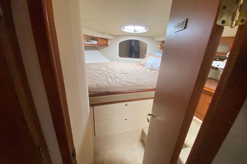 Slide: The Image of Cozy cabin interior of 2002 Cruisers Yachts 3572 Express with bed and storage. - 29