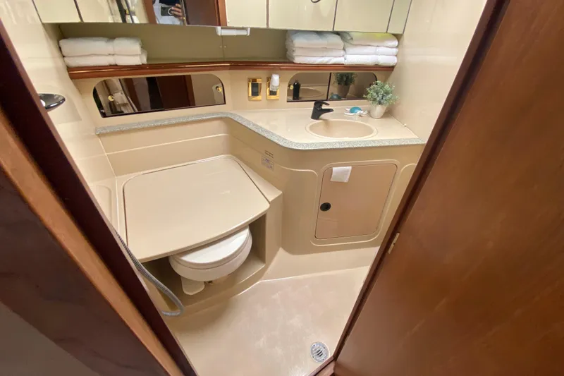 Slide: The Image of Luxurious bathroom in 2002 Cruisers Yachts 3572 Express, featuring modern amenities and elegant design. - 32