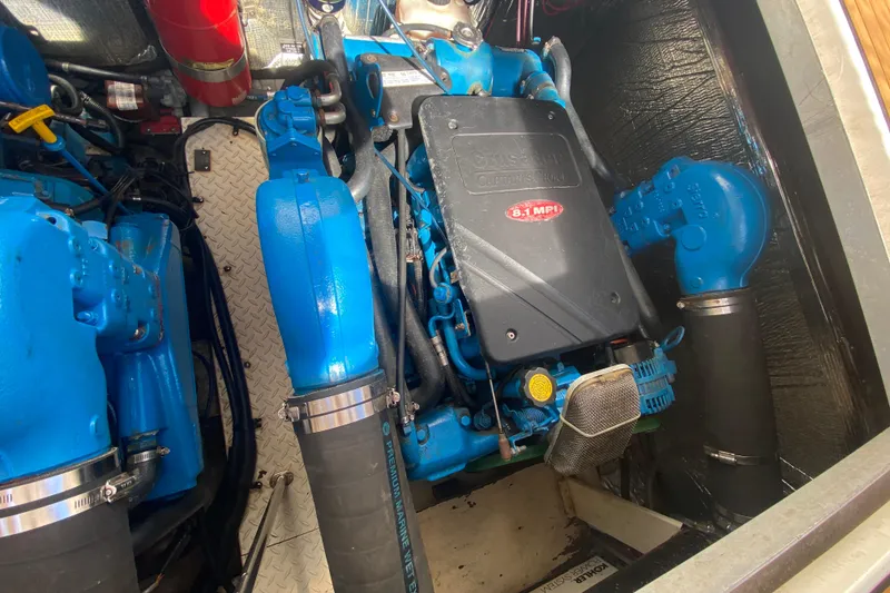 Slide: The Image of Engine compartment of 2002 Cruisers Yachts 3572 Express with blue marine engine components. - 36