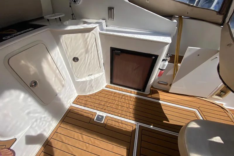 Slide: The Image of 2002 Cruisers Yachts 3572 Express interior with wood flooring and storage compartments. - 37