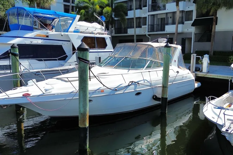 Slide: The Image of 2002 Cruisers Yachts 3572 Express docked at marina, surrounded by other boats. - 4