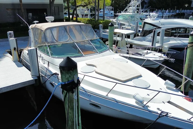 Slide: The Image of 2002 Cruisers Yachts 3572 Express docked at marina, featuring sleek design and spacious deck. - 5