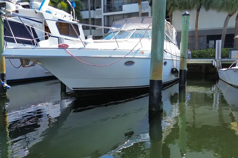 Slide: The Image of 2002 Cruisers Yachts 3572 Express docked at marina, surrounded by calm water. - 6