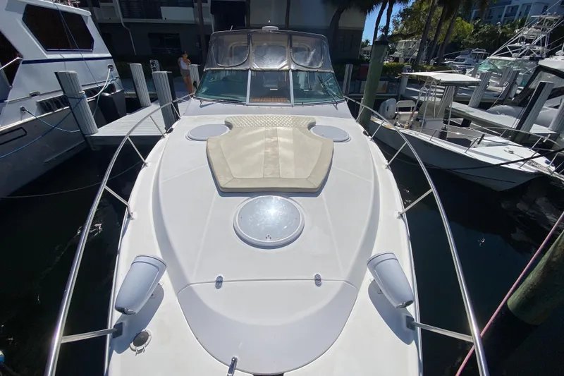 Slide: The Image of 2002 Cruisers Yachts 3572 Express docked, showcasing sleek design and spacious deck. - 7