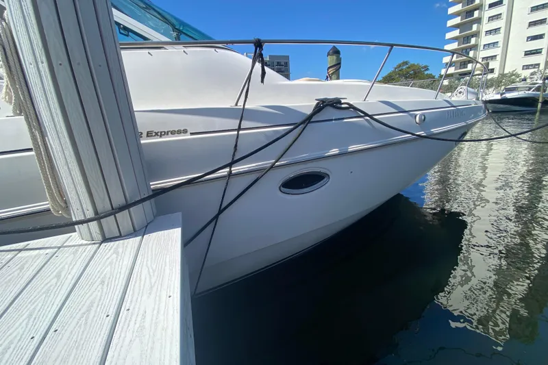 Slide: The Image of 2002 Cruisers Yachts 3572 Express docked at marina, clear blue sky. - 8