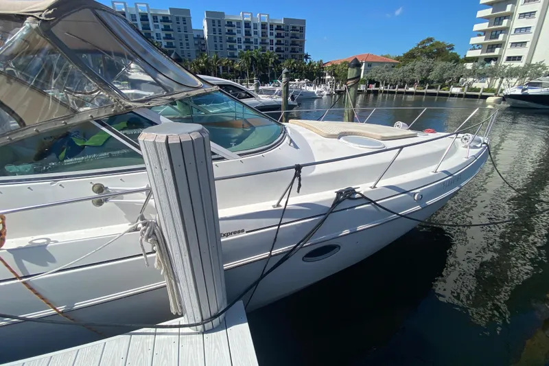 Slide: The Image of 2002 Cruisers Yachts 3572 Express docked at marina, sunny day, waterfront buildings. - 9