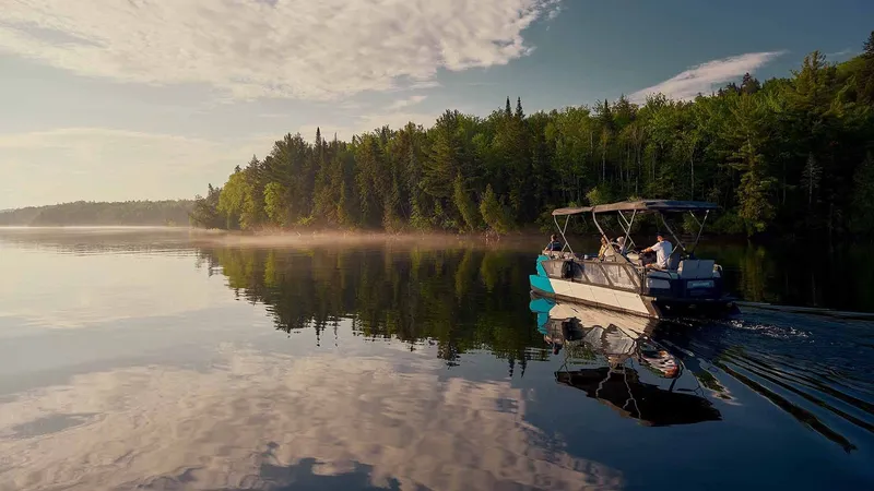 Slide: The Image of 2023 Sea-Doo Switch Cruise 21 on a tranquil lake at sunset. - 4