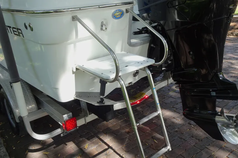 Slide: The Image of 2021 Clearwater 2200 Center Console boat with ladder and motor on trailer. - 11
