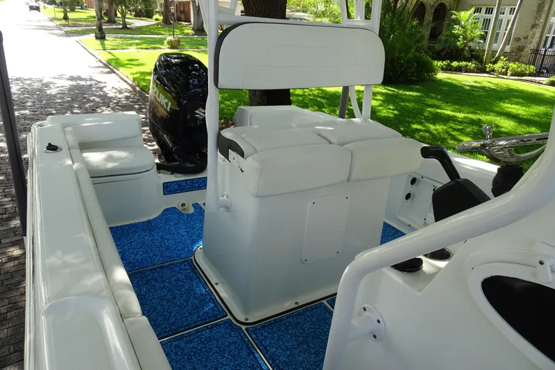 Slide: The Image of 2021 Clearwater 2200 Center Console boat interior with blue flooring and Suzuki engine. - 12