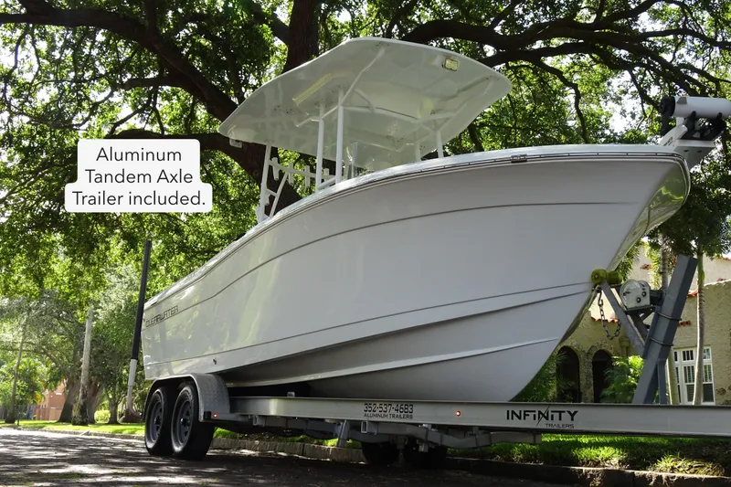 Slide: The Image of 2021 Clearwater 2200 Center Console boat on aluminum tandem axle trailer. - 2