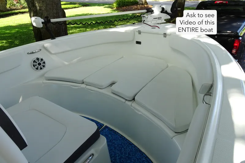 Slide: The Image of 2021 Clearwater 2200 Center Console boat interior with cushioned seating and trolling motor. - 5