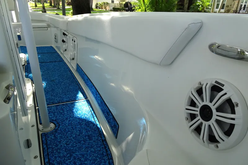 Slide: The Image of 2021 Clearwater 2200 Center Console boat interior with blue flooring and speaker. - 6
