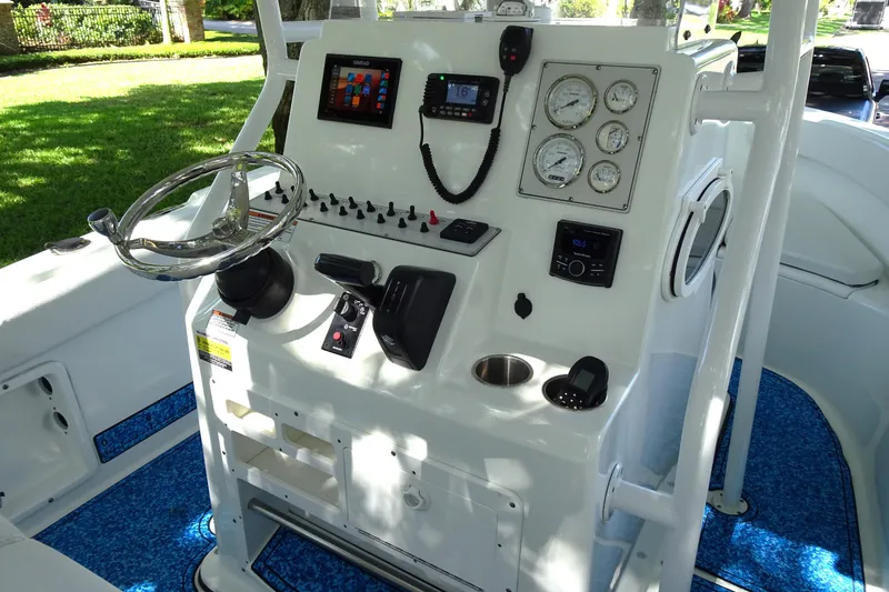 Slide: The Image of 2021 Clearwater 2200 Center Console boat dashboard with steering wheel and control panel. - 8