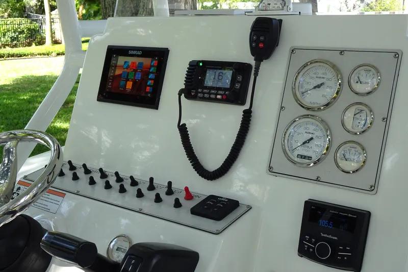 Slide: The Image of Center console dashboard of 2021 Clearwater 2200 boat with gauges and controls. - 9