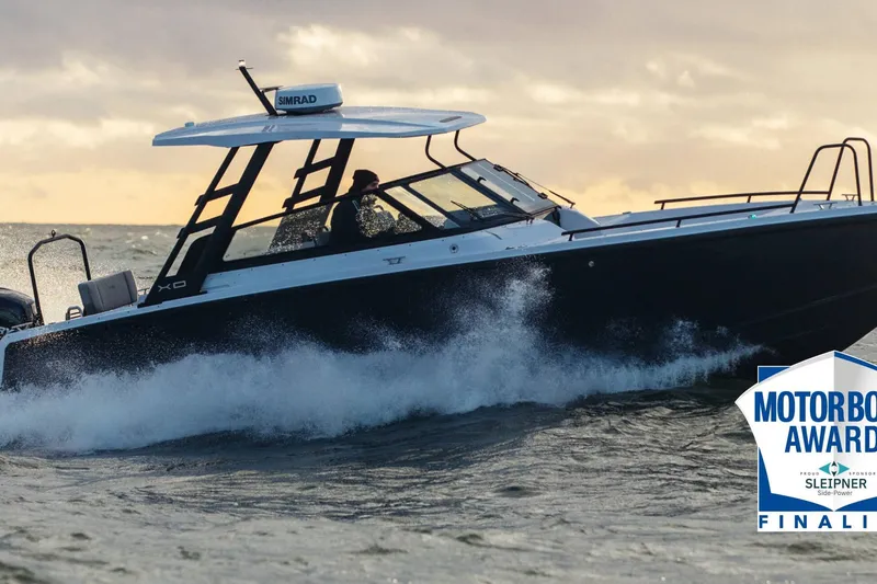 Slide: The Image of 2027 XO DSCVR 9 T-TOP boat navigating waves, Motorboat Awards finalist. - 12