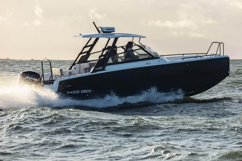 Slide: The Image of 2027 XO DSCVR 9 T-TOP boat cruising on open water at high speed. - 8