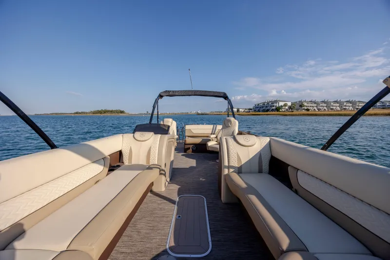 Slide: The Image of 2022 Godfrey Monaco 255 SFL pontoon boat with luxurious seating on calm water. - 10