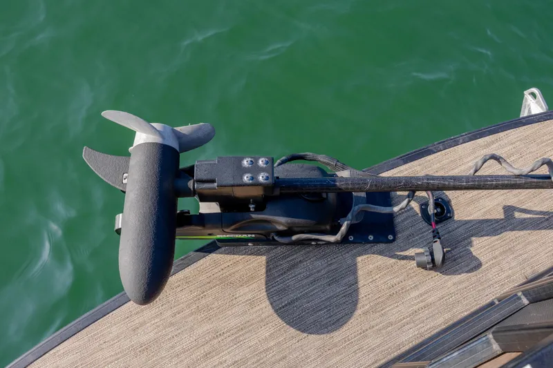 Slide: The Image of Trolling motor on 2022 Godfrey Monaco 255 SFL pontoon boat, over green water. - 11