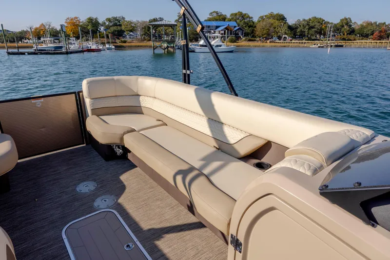 Slide: The Image of Luxurious seating on 2022 Godfrey Monaco 255 SFL pontoon boat, docked by scenic waterfront. - 13