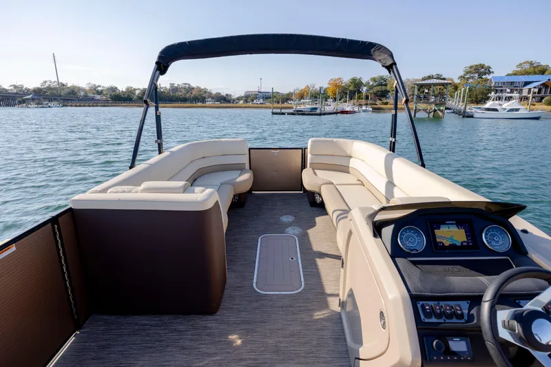 Slide: The Image of 2022 Godfrey Monaco 255 SFL pontoon boat interior with plush seating and modern dashboard. - 14