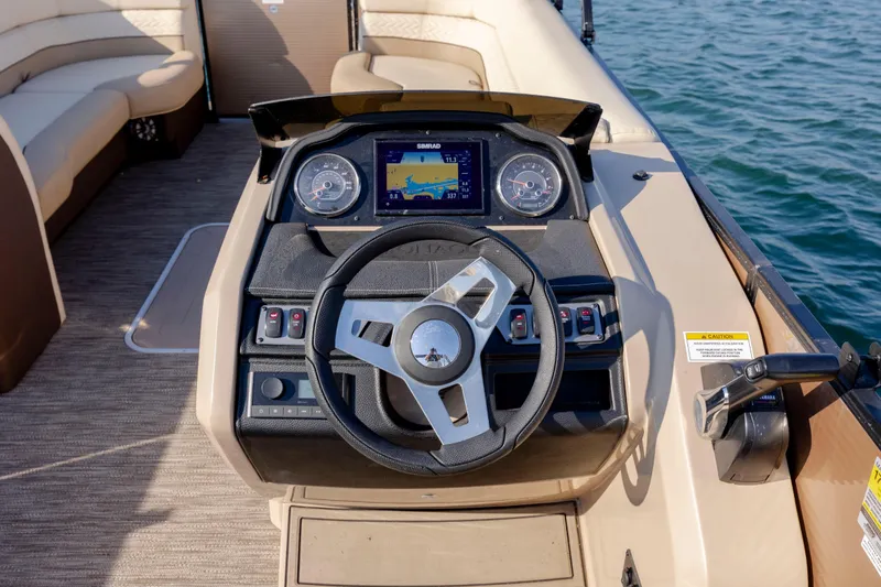 Slide: The Image of Steering console of 2022 Godfrey Monaco 255 SFL pontoon boat on water. - 16