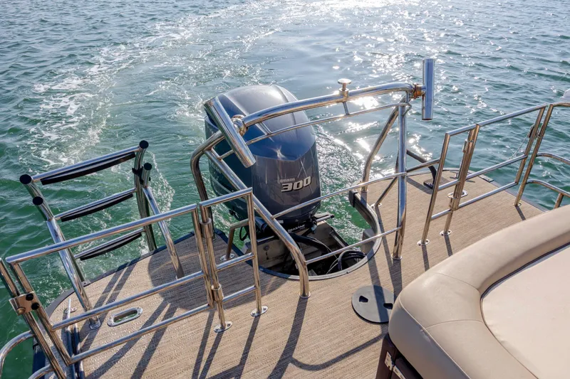 Slide: The Image of 2022 Godfrey Monaco 255 SFL boat with powerful outboard motor on water. - 22