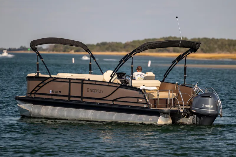 Slide: The Image of 2022 Godfrey Monaco 255 SFL pontoon boat on water with Yamaha engine. - 4