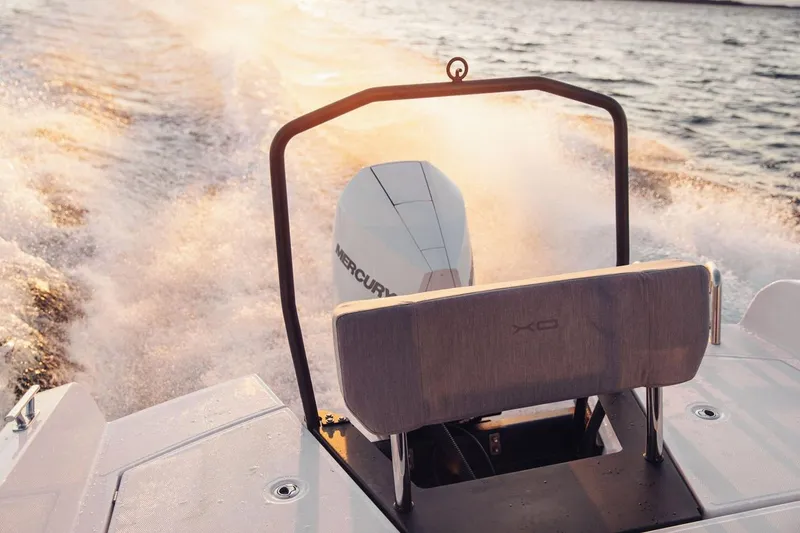 Slide: The Image of Sleek XO EXPLR 9 boat cruising on water at sunset, 2027 model. - 15