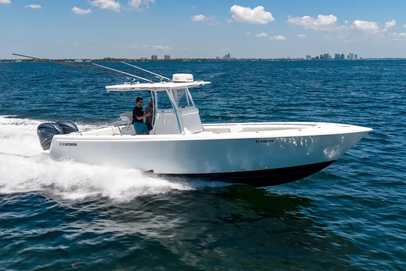 The Image of 2022 Contender 35 ST boat cruising on open water under a clear blue sky. - 0