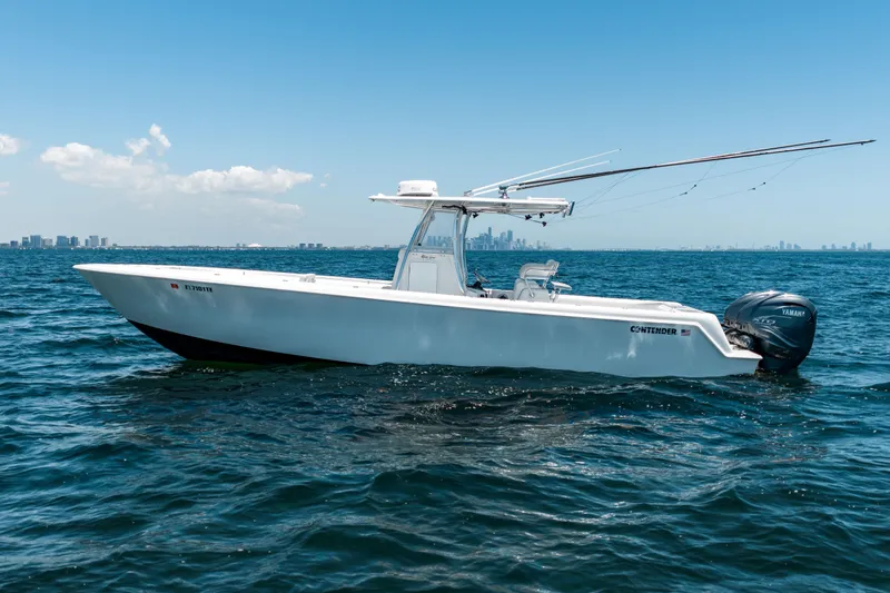 Slide: The Image of 2022 Contender 35 ST boat on open water with city skyline in background. - 12