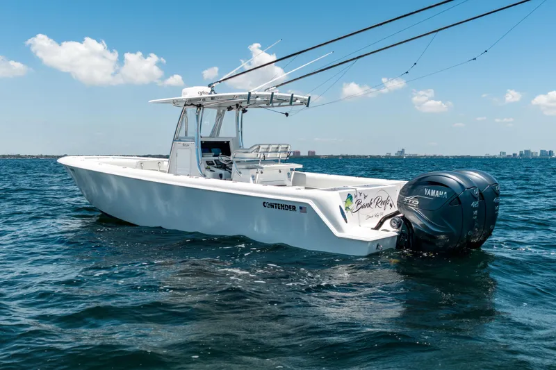 Slide: The Image of 2022 Contender 35 ST boat with dual Yamaha engines on open water. - 13