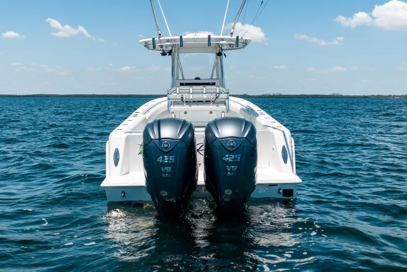 Slide: The Image of 2022 Contender 35 ST boat with dual Yamaha outboard engines on open water. - 14