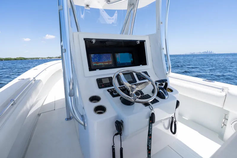 Slide: The Image of 2022 Contender 35 ST boat console with navigation screens on open water. - 18