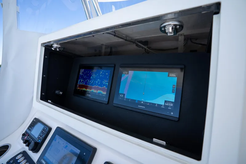 Slide: The Image of 2022 Contender 35 ST boat dashboard with Garmin navigation displays. - 19
