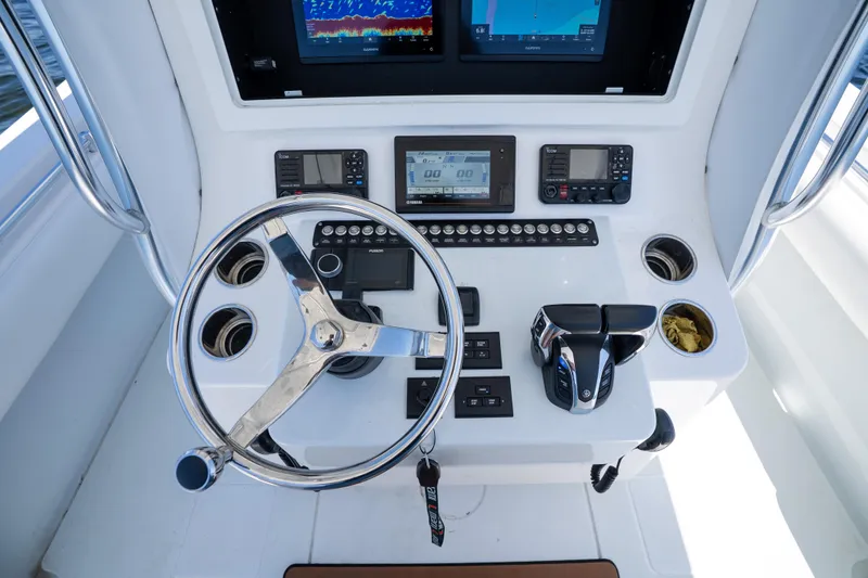 Slide: The Image of 2022 Contender 35 ST boat helm with steering wheel and navigation controls. - 20