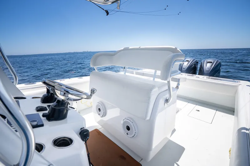 Slide: The Image of 2022 Contender 35 ST boat interior with helm, ocean view, and dual engines. - 21