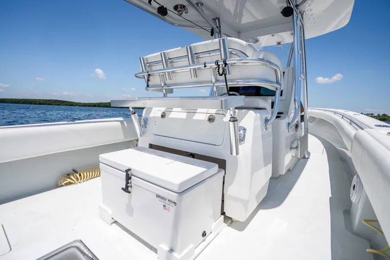 Slide: The Image of 2022 Contender 35 ST boat interior with seating and storage, on a sunny day. - 24