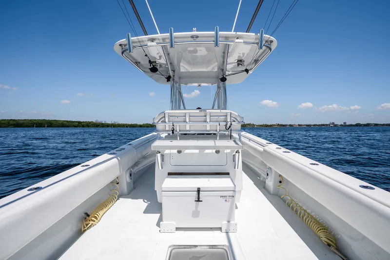 Slide: The Image of 2022 Contender 35 ST boat on open water under clear blue sky. - 26