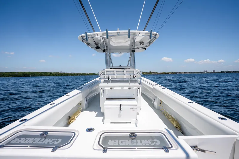 Slide: The Image of 2022 Contender 35 ST boat on open water under clear blue sky. - 27