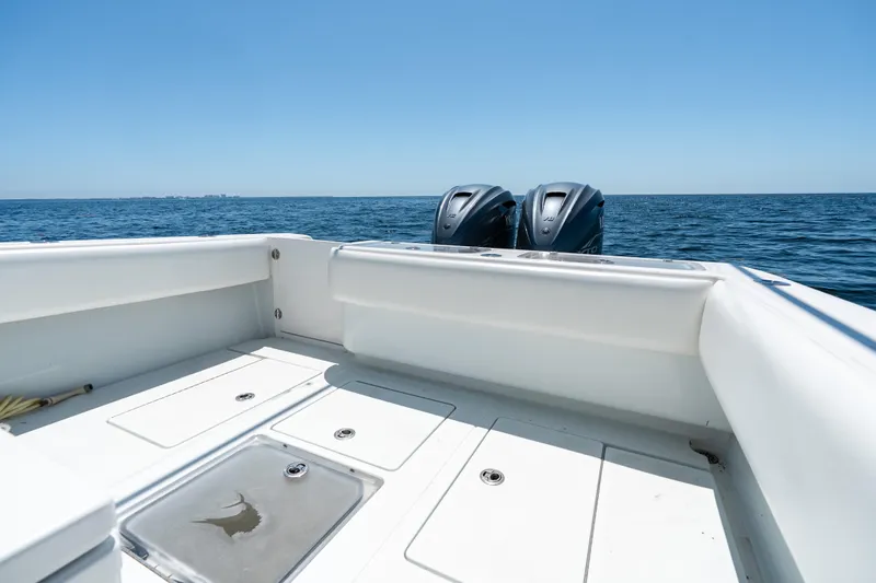 Slide: The Image of 2022 Contender 35 ST boat deck with twin engines on open sea. - 28