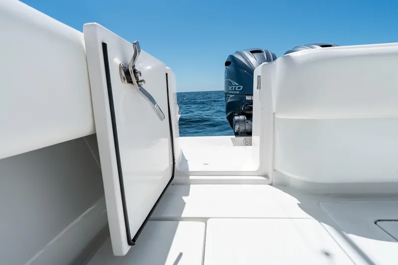 Slide: The Image of 2022 Contender 35 ST boat with open hatch and twin outboard motors on the ocean. - 31