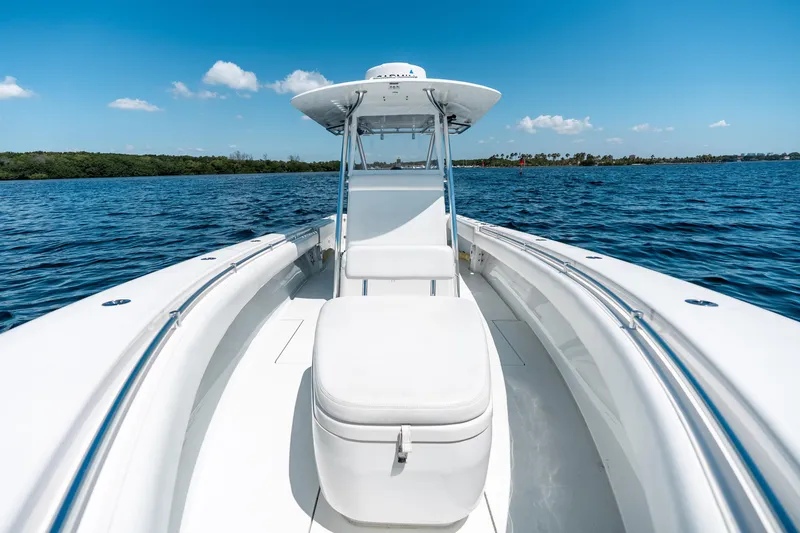 Slide: The Image of 2022 Contender 35 ST boat cruising on a sunny day, surrounded by blue water. - 32