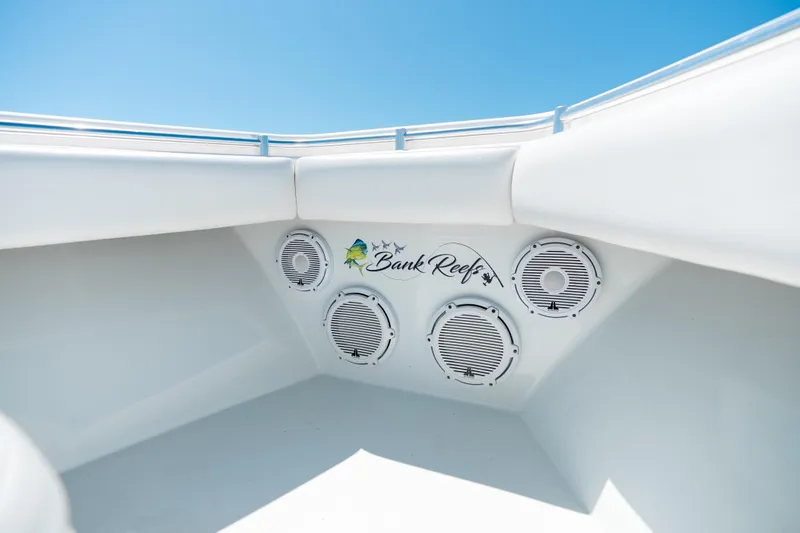 Slide: The Image of 2022 Contender 35 ST boat speakers with "Bank Reefs" logo under clear blue sky. - 38