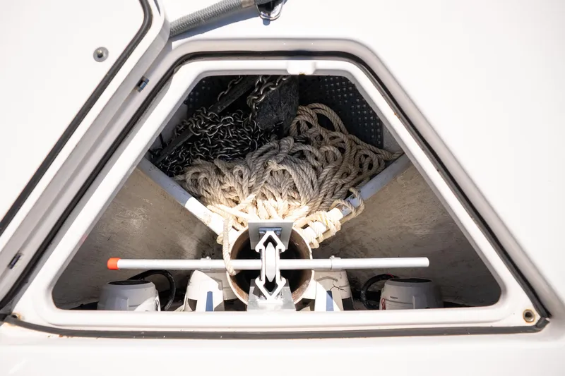 Slide: The Image of Anchor storage compartment on 2022 Contender 35 ST boat, featuring ropes and chains. - 47