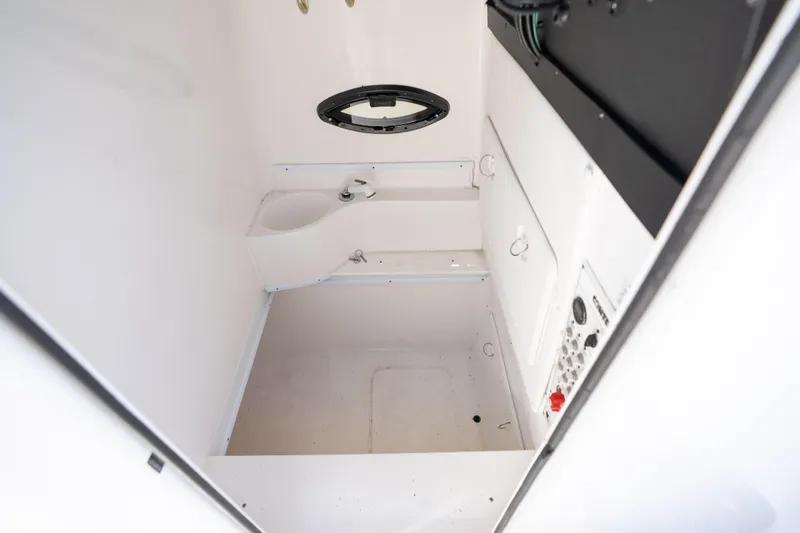 Slide: The Image of Interior of 2022 Contender 35 ST boat, featuring a compact, white marine bathroom. - 48