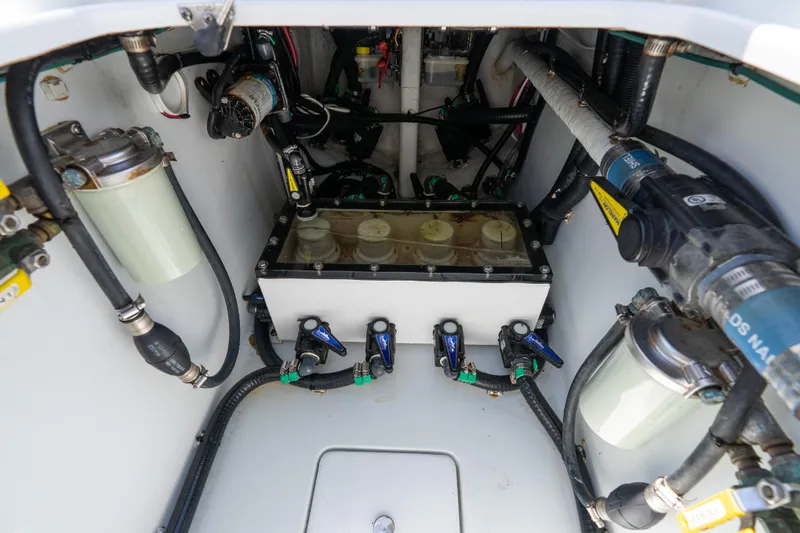 Slide: The Image of Engine compartment of 2022 Contender 35 ST boat, showcasing fuel filters and hoses. - 49